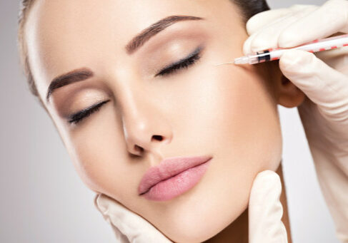 Woman getting cosmetic injection of botox near eyes, closup. Woman in beauty salon. plastic surgery clinic.